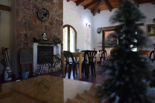 a christmas tree in a living room with a fireplace at Estancia Santa Leocadia in Bialet Massé