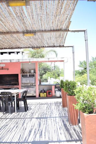 a patio with a table and chairs and a kitchen at Estancia Santa Leocadia in Bialet Massé