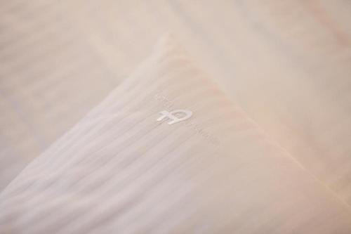a pair of scissors sitting on top of a white curtain at Hotel Alexander in Kraków