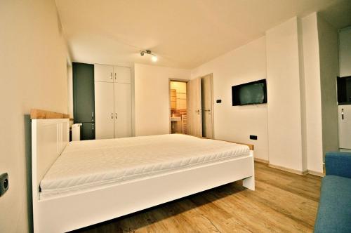 a bedroom with a white bed in a room at Veselý - vinný sklep in Moravská Nová Ves