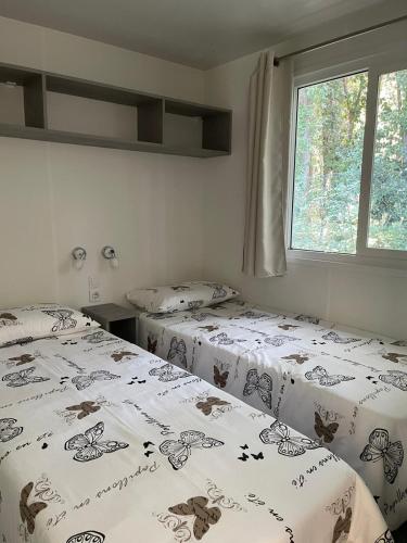 a bedroom with two beds with butterflies on them at Dolores ONLY 250 METERS TO THE BEACH in Banjole