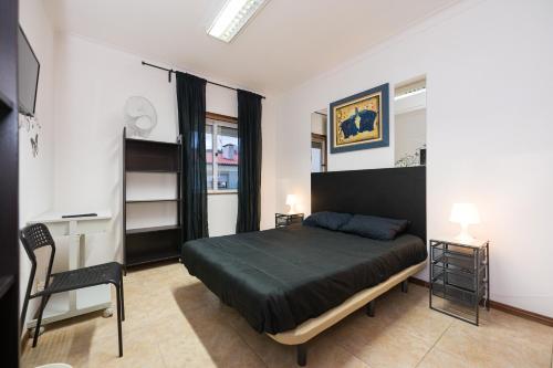 En eller flere senge i et værelse på Novas Direcões, LDA - NOVA GERÊNCIA 2021