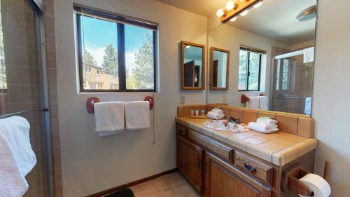 y baño con lavabo y espejo. en Snowflower #81 Condo, en Mammoth Lakes