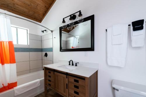 a bathroom with a sink and a tub and a mirror at Casa Secoya in Monte Rio