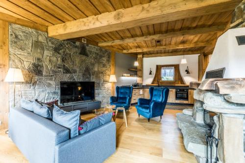 a living room with a large stone wall at Apartament Krokus in Kościelisko