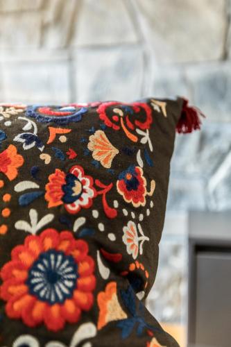a black pillow with a floral pattern on it at PREMIUM Apartament Krokus - Giewont View in Kościelisko