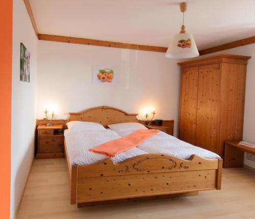 a bedroom with a wooden bed and two night stands at Wirtshausbrennerei Krenn in Yspertal
