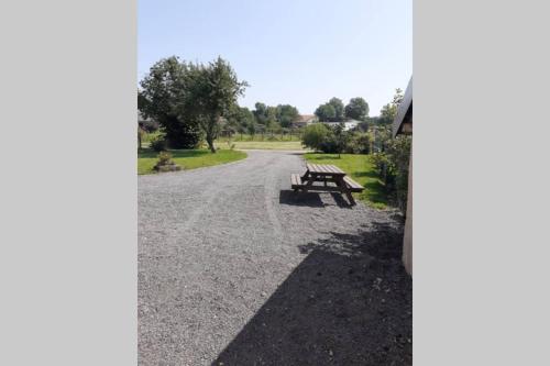 a picnic bench sitting on the side of a road at Le 9 rue du moulin 4-5 personnes tout confort in Gripport