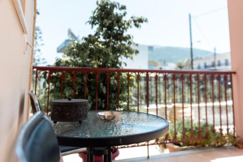 a table on a balcony with a tea pot on it at Kosta's Apartments in Vonitsa
