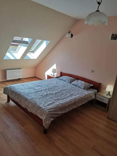 a bedroom with a bed in a room with skylights at Boczna 9 Apartament in Karpacz