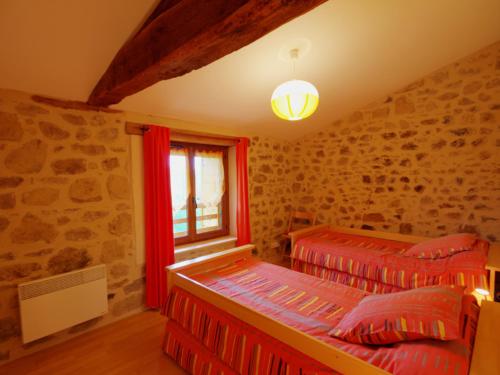 a bedroom with two beds and a window at Gîte Saint-Cyr-de-Valorges, 5 pièces, 8 personnes - FR-1-496-17 in Échanssieux