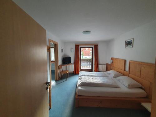 Postel nebo postele na pokoji v ubytování ALBERGO BAR RISTORANTE DOLOMIA