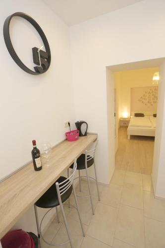 a room with a table with chairs and a mirror on the wall at Zadar Street Apartments and Room in Zadar