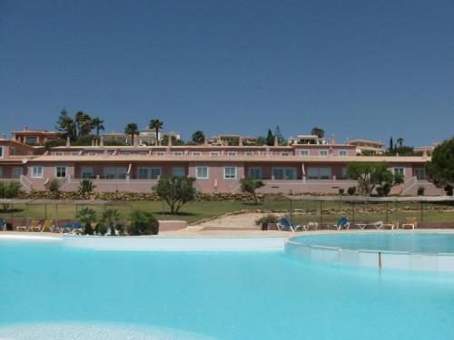 a large swimming pool in front of a large building at Belver Porto Dona Maria Resort in Luz