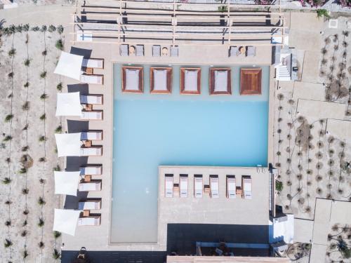 an overhead view of a building with a large pool at Ammothines Cycladic Suites in Naxos Chora