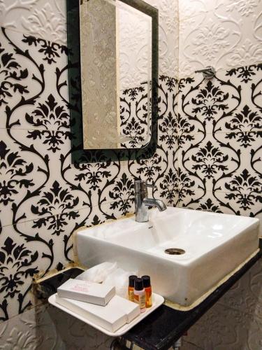 a bathroom with a sink and a mirror at Dwivedi Hotels Sri Omkar Palace in Varanasi