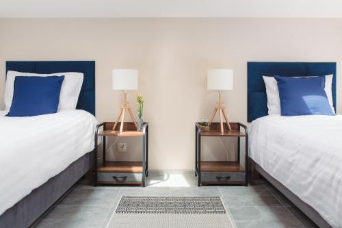 two beds sitting next to each other in a bedroom at Pod Jasną 28 in Częstochowa