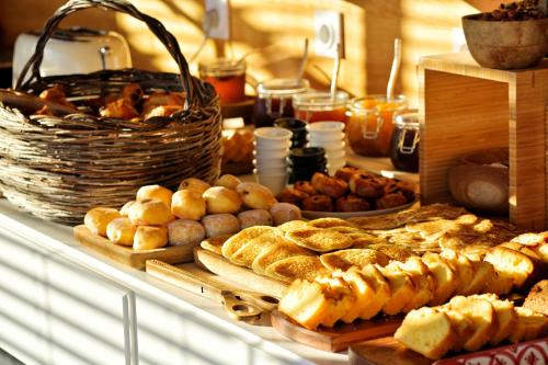 a buffet of bread and pastries on a table at Hôtel Serenada in Algajola