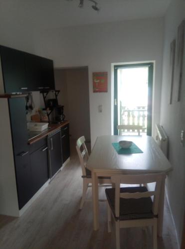 eine Küche und ein Esszimmer mit einem Tisch und Stühlen in der Unterkunft Ferienwohnung Eddi in Reichenbach im Vogtland