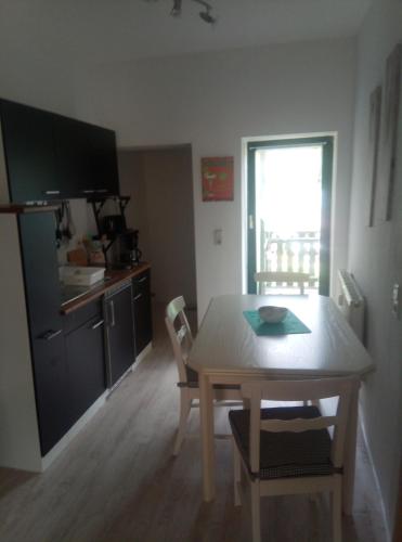 a kitchen and dining room with a table and chairs at Ferienwohnung Eddi in Reichenbach im Vogtland