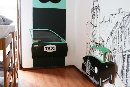 a bedroom with a car mural on the wall at Hostel 2300 Thomar in Tomar