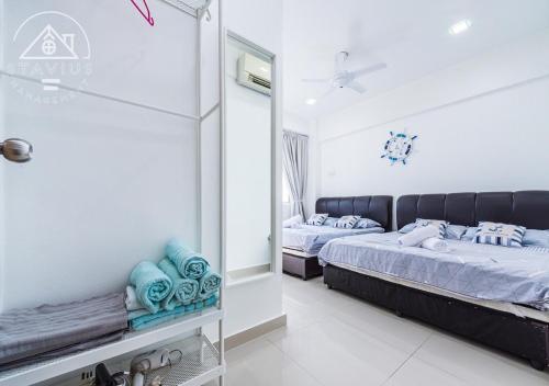 a bedroom with two beds and a mirror at Port Dickson 10Pax 3BR Glory Beach Resort Seaview in Port Dickson