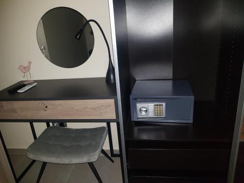 a desk with a mirror and a chair next to a table at Glyfada Beach Hotel in Glyfada