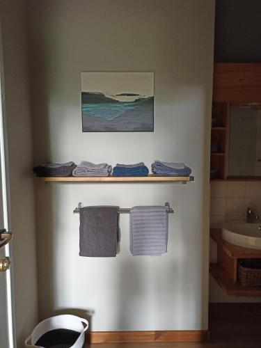 a bathroom with three towels hanging on a wall at Le Thirifays in Chiny