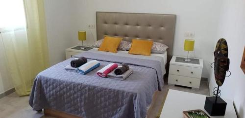 a bedroom with a bed with pillows and towels on it at Oleza Garden - Laguna Rosa - Playa Flamenca - Pool & Garden View. in Playa Flamenca