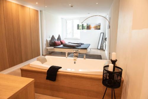 a bathroom with a large tub in a room at The City Suite - Luxuswohnung in Kempten