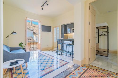 a living room with a couch and a table at Mosaiko Homes Catedral Granada in Granada