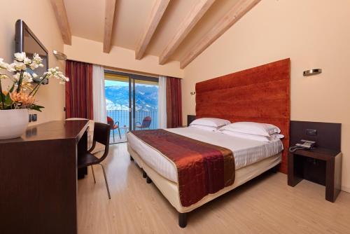 a hotel room with a bed and a desk and a desk at Hotel Europa in Malcesine