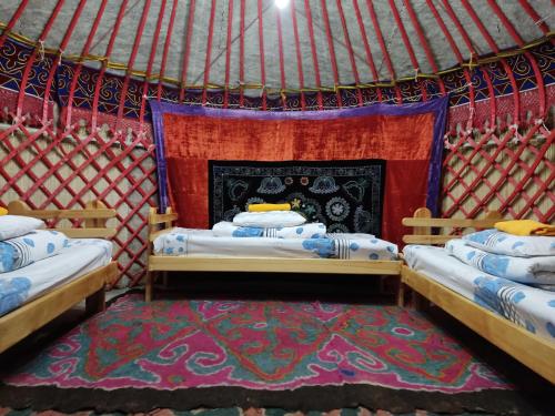 a room with two beds in a yurt at Karakol Yurt Lodge & Homestay in Karakol