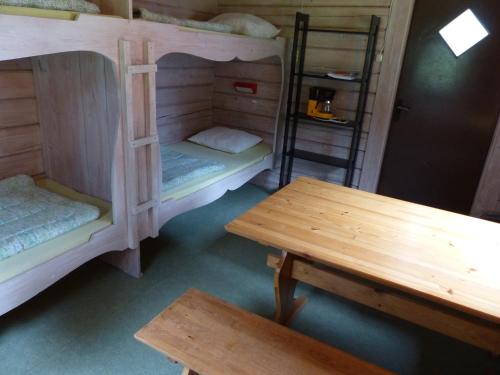 a room with two bunk beds and a table at Björkebo Camping in Stöllet