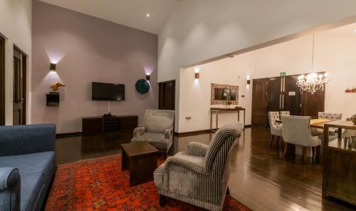 a living room with a couch and chairs and a table at Galway Heights Hotel in Nuwara Eliya