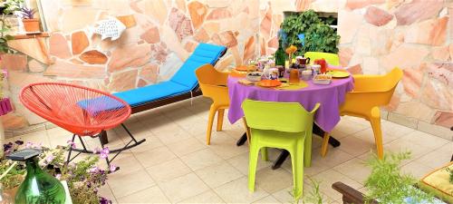 a colorful table and chairs in a restaurant at B&B In Centro in Cagliari