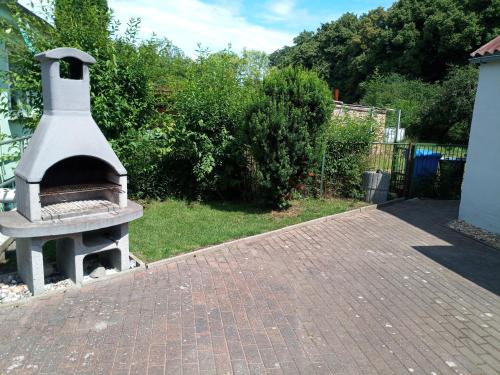 a pizza oven sitting on top of a brick patio at kleines gemütliches Ferienhaus in Poseritz