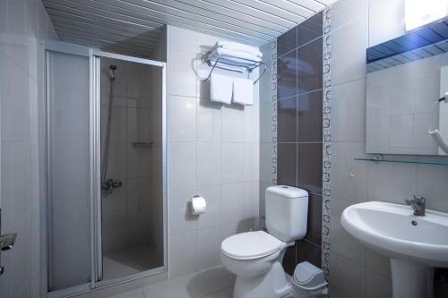 a bathroom with a toilet and a shower and a sink at Angora Apart Hotel in Alanya