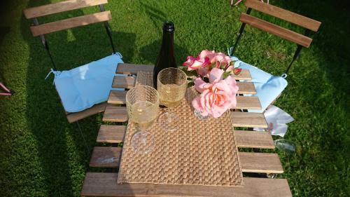 a picnic table with wine glasses and flowers on it at Robin Hood's Bay Coastguard's Cottage with a View in Robin Hood's Bay