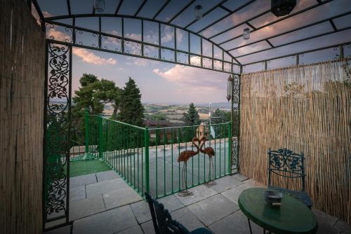 a room with a balcony with a table and a view at Il Mulino in Civitella deʼ Conti
