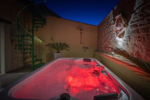 a bath tub with red light in a room at Il Mulino in Civitella deʼ Conti