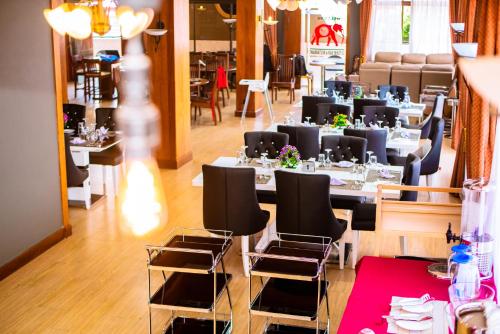 a restaurant with tables and chairs in a room at LEYSHOF HOTEL in Mwanza