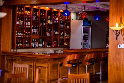 a bar with a lot of bottles of alcohol at LEYSHOF HOTEL in Mwanza