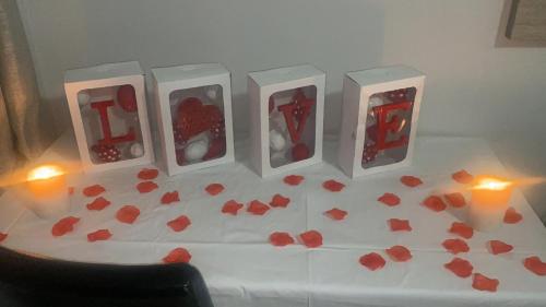 a table with hearts on it with candles and a table with hearts at Ndzuti Guest House in Witbank