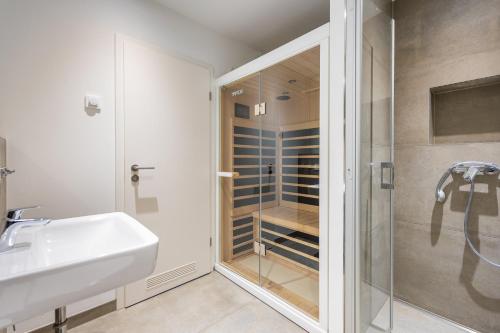a bathroom with a shower and a sink and a toilet at Marina Martinshafen in Sassnitz