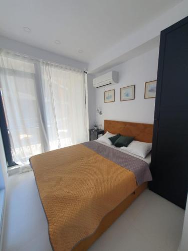 a bedroom with a bed and a window at Sea view Oxygen Neptun in Neptun