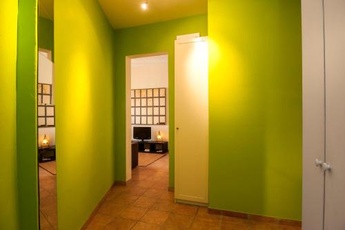a hallway with green and yellow walls and a door at Gaudi Apartment 2 in Barcelona