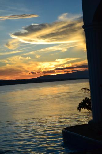 a sunset over a large body of water at Eden Resort in Santander