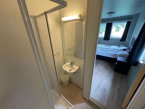 a small bathroom with a sink and a mirror at Gjøa Motell in Rosendal