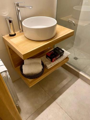 a bathroom with a sink and a glass shower at NB Mountain aparts El Chalten in El Chalten